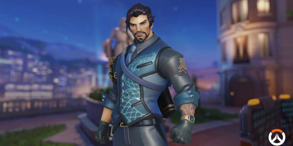 Hanzo in a blue outfit with tattoos and a wristwatch stands confidently against a picturesque urban backdrop