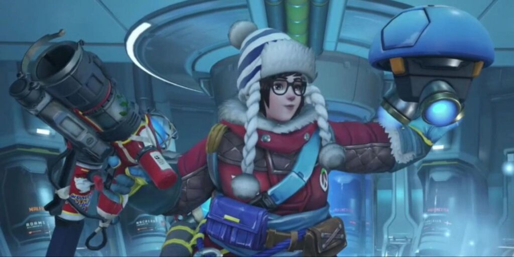 Mei in her Ecopoint: Antarctica skin from Overwatch 2, wearing a red winter jacket, striped pom-pom hat, and holding a cryo-device in a high-tech arctic facility