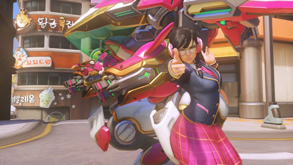 D.Va in a school uniform confidently poses with finger guns in front of a vibrant, futuristic pink and gold mech